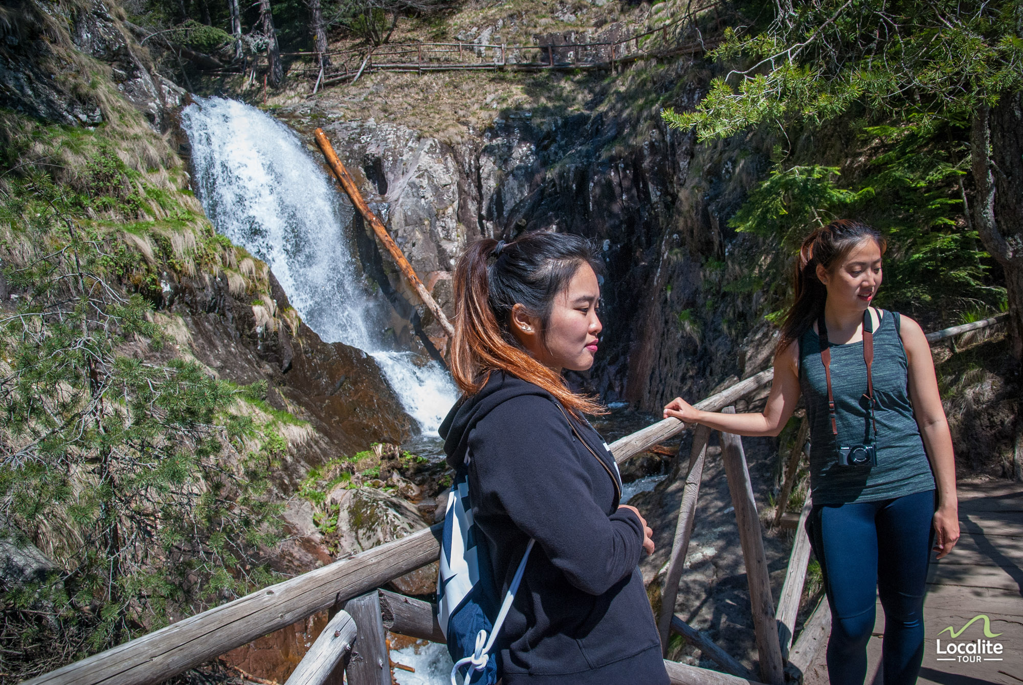 Two girls on a wooden bridge at one of the waterfalls on the Waterfalls canyon hike