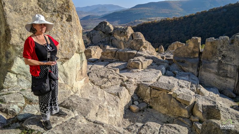 Lady tourist looking at the ruins of Perperikon